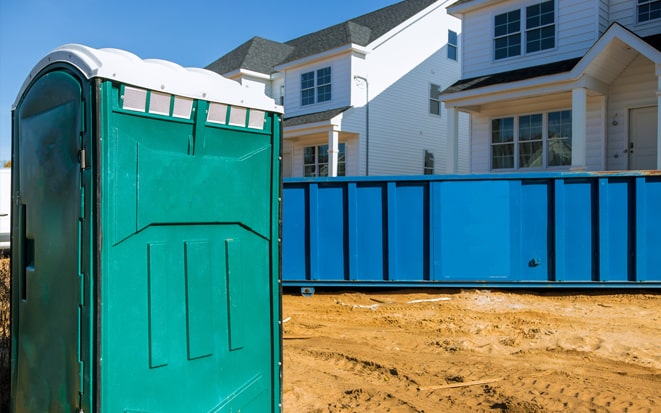 dumpster and portable toilet at a construction site in sarasota fl